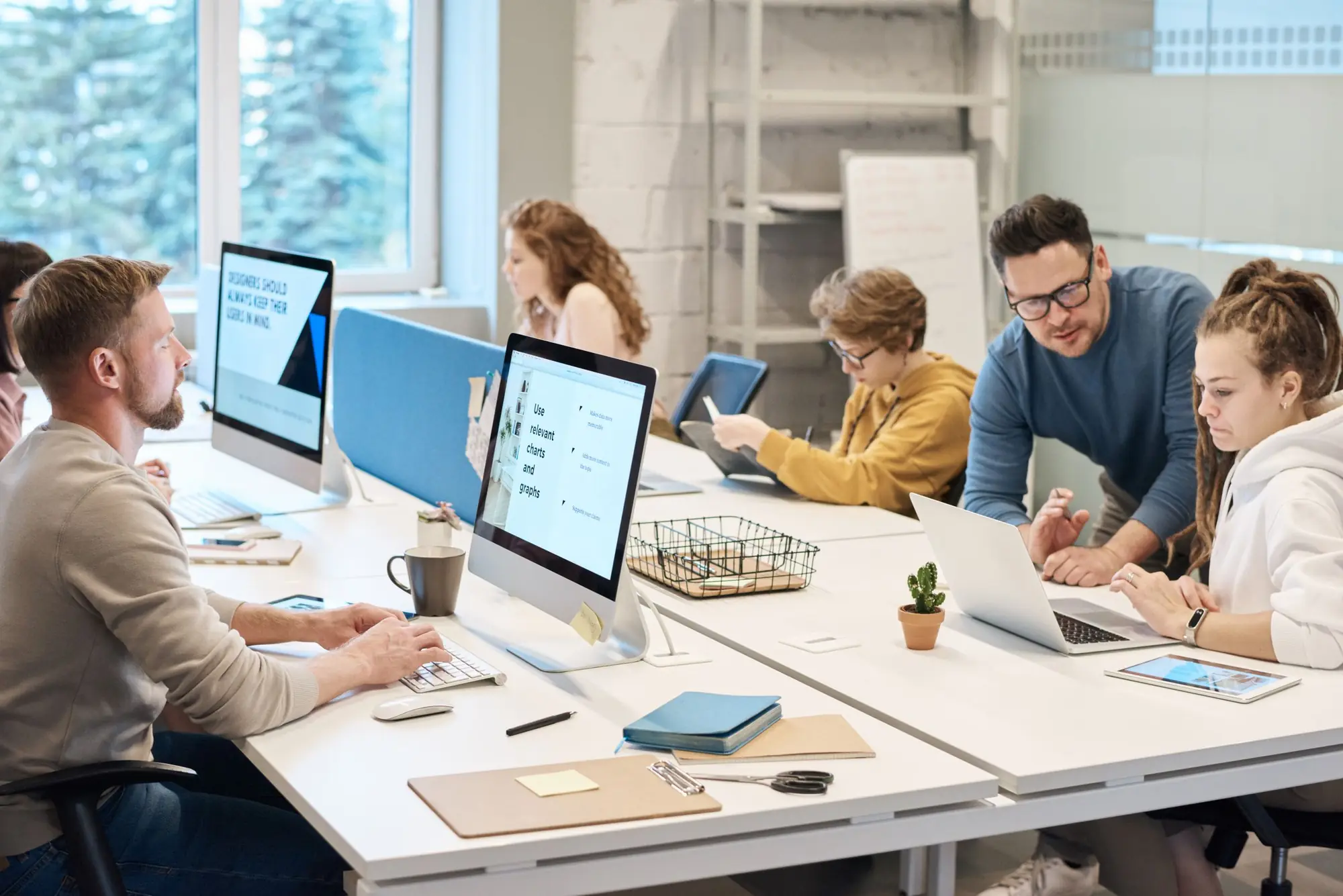 Software team working at computers in a bright open-plan office